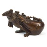 A Japanese bronze figure of a rat pulling a hotei sack covered in it's young,