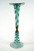 A Victorian flared glass vase with green and white dragged overlay on a similar flared base,