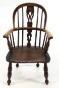 A child's antique Windsor chair with bentwood rail and arms,