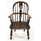 A child's antique Windsor chair with bentwood rail and arms,
