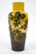 An Exeter Art pottery terracotta vase, slip decorated with fruit blossom, impressed mark to base,