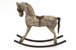 An Indian carved wood and metal mounted rocking horse 84cm high x 71cm long