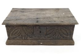 An 18th century oak two handled Bible box, dated 1702, with leaf carved front,