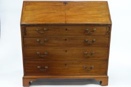 A 19th century mahogany bureau with fall front above four graduated drawers on bracket feet