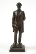 A bronze patinated figure of the statue of Abraham Lincoln holding the Emancipation Proclamation,