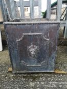 A lead orange tree stub style planter with framed central panels of lion masks to each face,