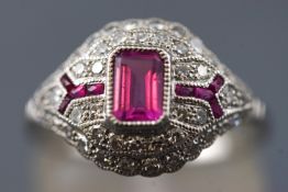 A white metal dress ring. Set with a rectangular cut pink sapphire of approximately 0.50cts.