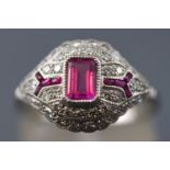 A white metal dress ring. Set with a rectangular cut pink sapphire of approximately 0.50cts.