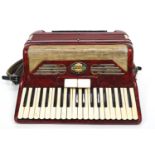 A red Pigliacampo piano accordian,