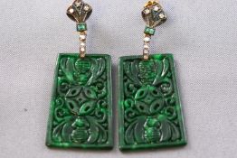 A pair of yellow and white metal drop earrings each having a carved rectangular nephrite (untested)