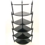 An ebonised Victorian style six tier waterfall what not with barley twist supports,