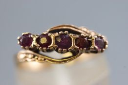 A collection of two items to include a hallmarked 9ct gold five stone garnet ring, size L,