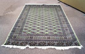 A green ground Bokhara carpet,