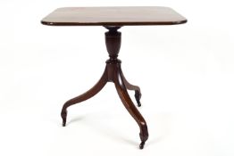 A mahogany rectangular table on a tripod base, with brass castors, h 57cm,