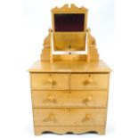 A Victorian pine dressing table chest, two short and two long drawers surmounted by a mirror,