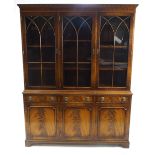 A George III style mahogany bookcase with astragal glazed top above three drawers above two