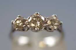 A white metal three stone ring,