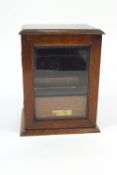 An oak smokers companion cabinet with glazed door