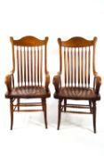 A pair of oak spindle back elbow chairs,
