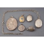 A collection of six white metal locket pendants of variable designs,