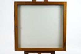 An oak frame collector's wall frame with chalk white interior,
