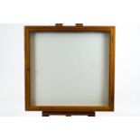 An oak frame collector's wall frame with chalk white interior,