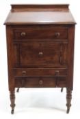 A Victorian and later mahogany clerks desk on turned legs with brass and ceramic casters,