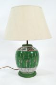 A Chinese porcelain ginger jar, decorated with Canton enamels, converted to a table lamp with shade,