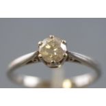 A white metal single stone ring, set with a round brilliant cut diamond, stamped weight of 0.75cts.