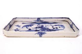 A Chinese porcelain spoon tray, painted in underglaze blue with figures in a landscape, 17cm x 10.