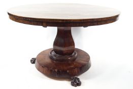 A William IV goncola alves circular centre table on baluster pedestal with three carved lion paw
