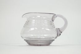 A 19th century lead glass jug of bellied cylindrical form with a four ring neck and base