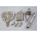 A silver chatelaine clip, decorated with C and S scrolls and a mask with loops for three chains,