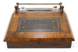 A walnut desk top writing slope with inset embossed leather surface and two ink bottles,