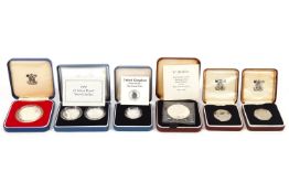 Twenty two boxed silver coins to include £1, £2 two coin sets and Royal Commemoratives.