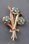 A collection of two brooches consisting of a white metal bar brooch