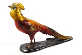 A cold painted metal cigar lighter in the form of a golden pheasant,