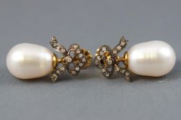 A yellow and white metal pair of drop earrings,