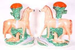 A pair of polychrome decorated flatback Staffordshire spill vases,