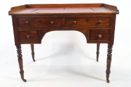 An early 19th century mahogany writing/architects desk with galleried rectangular top