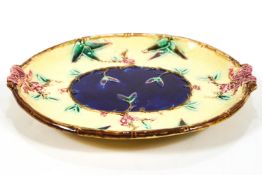 A Victorian Majolica oval platter with a moulded bamboo edge, bows and blossom decoration,