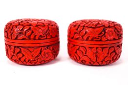 A pair of red cinnabar round form boxes with pull off lids,