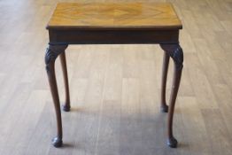 A mahogany centre table, the cabriole legs with shell carved knees on pad and turned feet,