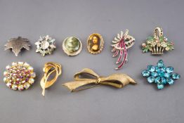 A collection of twenty costume brooches of variable designs.