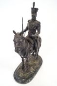 A bronze statue of a cavalryman on a horse standing on marble base,