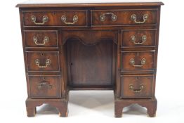 A mahogany knee hole desk, eight drawers set with drop handles, height 79cm, width 92cm,