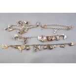 A collection of four silver charm bracelets , each fitted with various charms.