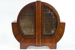 A 1930's mahogany veneered display cabinet of unusual round form,