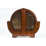 A 1930's mahogany veneered display cabinet of unusual round form,