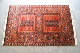 A Mossoul virgin wool carpet with two central panels on a rust field